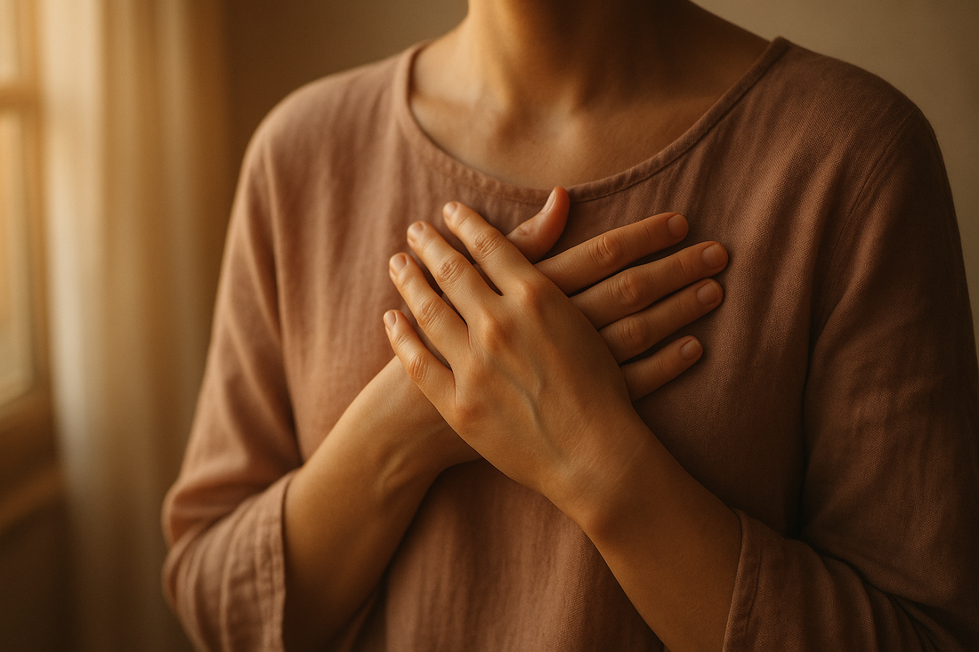 Hands placed gently over heart in warm light representing self-compassion breaks for chronic shame practice