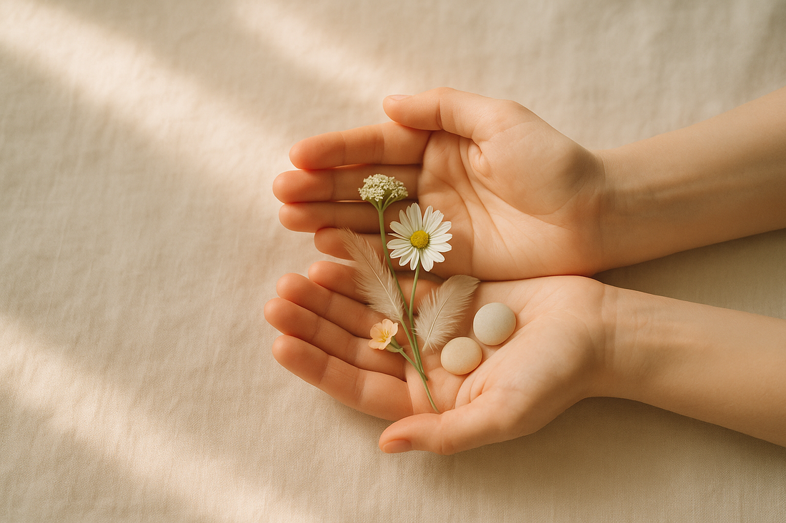 Open hands cradling wildflowers and stones symbolizing self-compassion in body-focused repetitive behaviors recovery