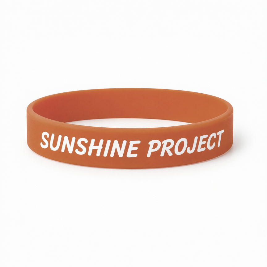 Orange wristband with 'SUNSHINE PROJECT' text on a white background
