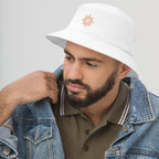 The Sunshine Project cotton bucket hat in white, angled front view