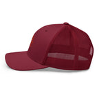 The Sunshine Project mesh-back trucker hat in cranberry red, left side view