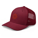 The Sunshine Project mesh-back trucker hat in cranberry red, angled front view