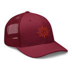 The Sunshine Project mesh-back trucker hat in cranberry red, angled front view