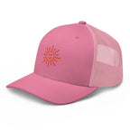 The Sunshine Project mesh-back trucker hat in pink, angled front view
