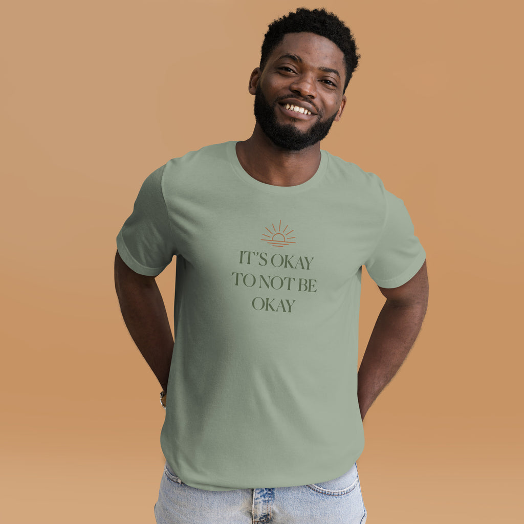 The Sunshine Project It's Okay to Not Be Okay tee in sage green, front view