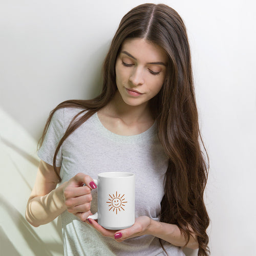 The Sunshine Mug, white glossy 15 oz mug, lifestyle view with a woman