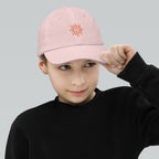 The Sunshine Project youth baseball cap in Pink, front view