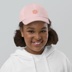 The Sunshine Project youth baseball cap in Pink, front view