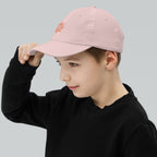 The Sunshine Project youth baseball cap in Pink, left side view