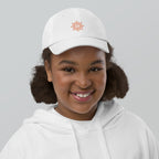 The Sunshine Project youth baseball cap in White, front view