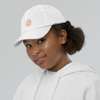 The Sunshine Project youth baseball cap in White, left side view